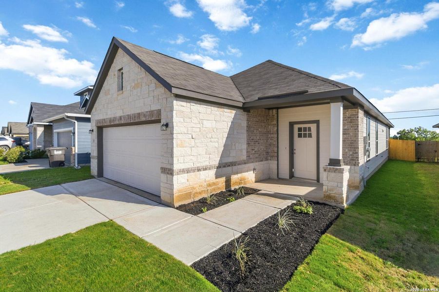 Front exterior of a new home in Katzer Ranch, Converse, TX, highlighting curb appeal (Image 2). Front exterior of a new home in Katzer Ranch, Converse, TX, highlighting curb appeal (Image 2).