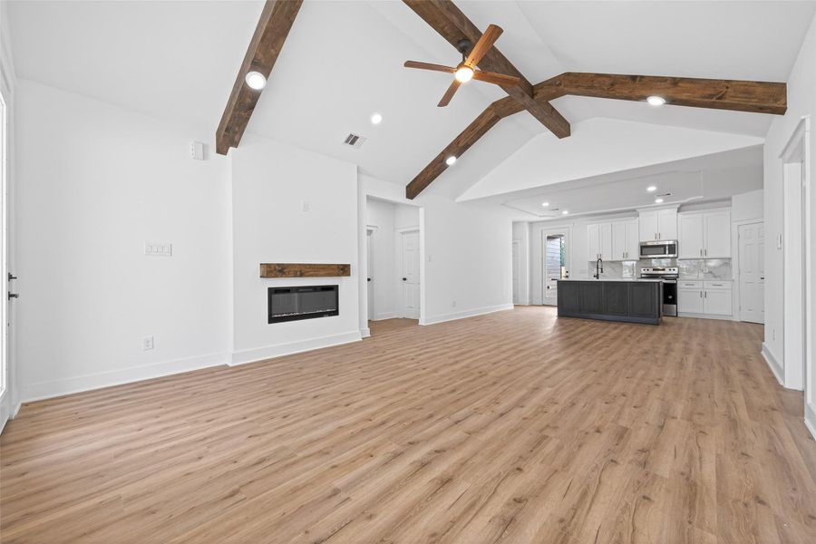Bright and open entry leading into the main living space with soaring ceilings and natural light.