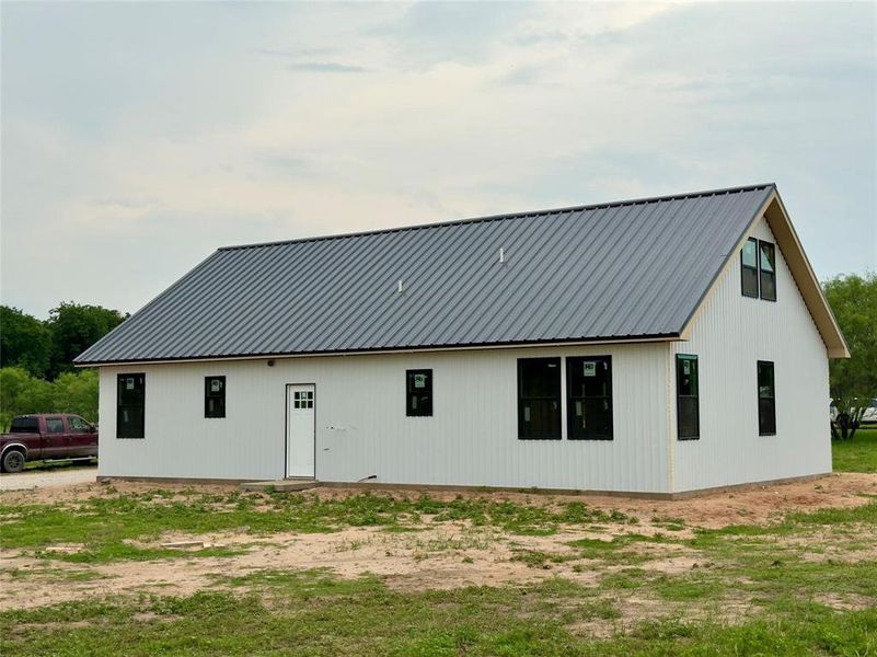 Back of property featuring a metal roof