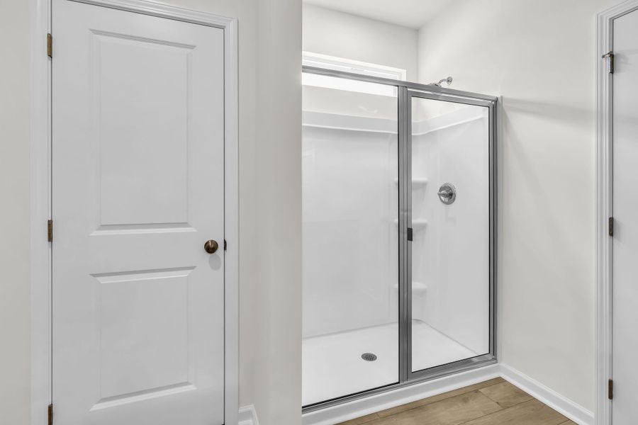 Walk in shower with additional storage to the left. Walk in shower with additional storage to the left.