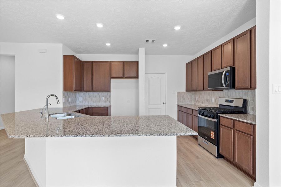 This spacious kitchen has it all—ample storage, generous counter space, and a layout that truly makes it the heart of the home. This spacious kitchen has it all—ample storage, generous counter space, and a layout that truly makes it the heart of the home.