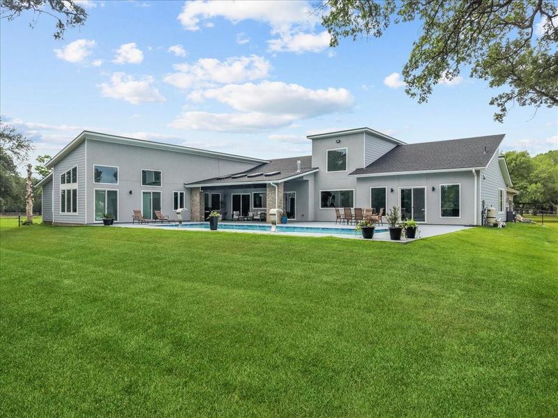 50ft salt water pool, spacious covered patio, and lush green grass!