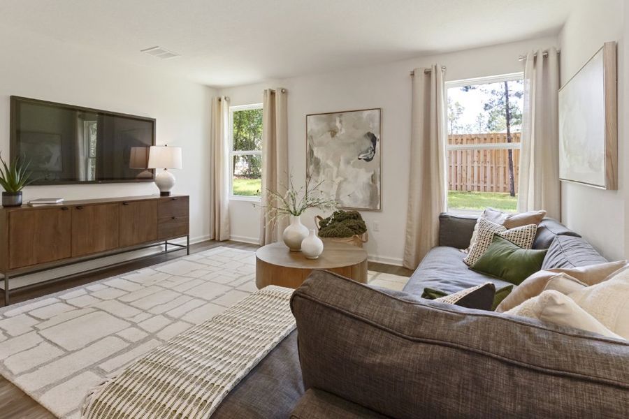 A living room with a couch and a table. A living room with a couch and a table.