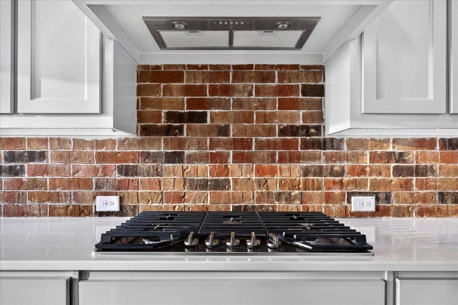 Doug Parr Homes | Gas Cooktop with Brick Backsplash
