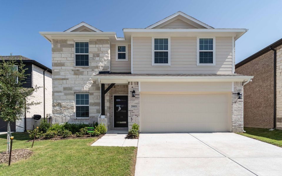 Front exterior of a new home in Travis Ranch, Forney, TX, highlighting curb appeal (Image 1). Front exterior of a new home in Travis Ranch, Forney, TX, highlighting curb appeal (Image 1).