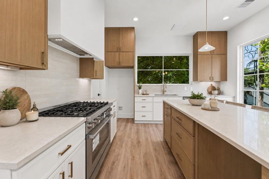 Well-appointed kitchen with a gas range, abundant cabinetry and ample counter space. Well-appointed kitchen with a gas range, abundant cabinetry and ample counter space.