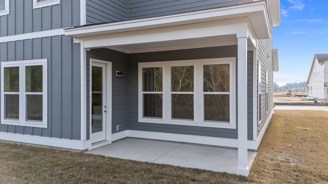 Exterior details and patio area of a home in Blue Heron Retreat: Oasis Series, Little River (Image 4).