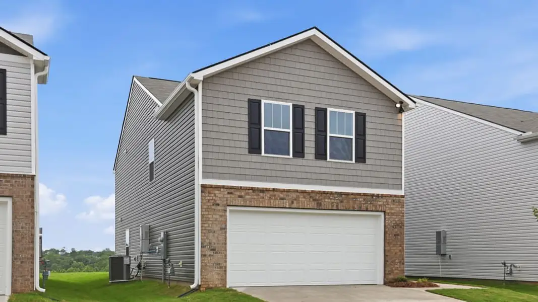 Front exterior of a new home in Harrier Point, Woodruff, SC, highlighting curb appeal (Image 2). Front exterior of a new home in Harrier Point, Woodruff, SC, highlighting curb appeal (Image 2).