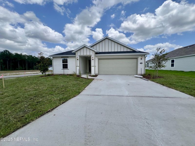 Front exterior of a new home in Bellbrooke, Jacksonville, FL, highlighting curb appeal (Image 1).
