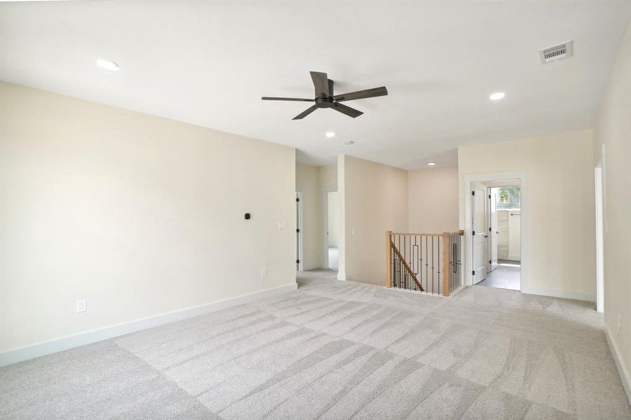 Carpeted spare room with ceiling fan