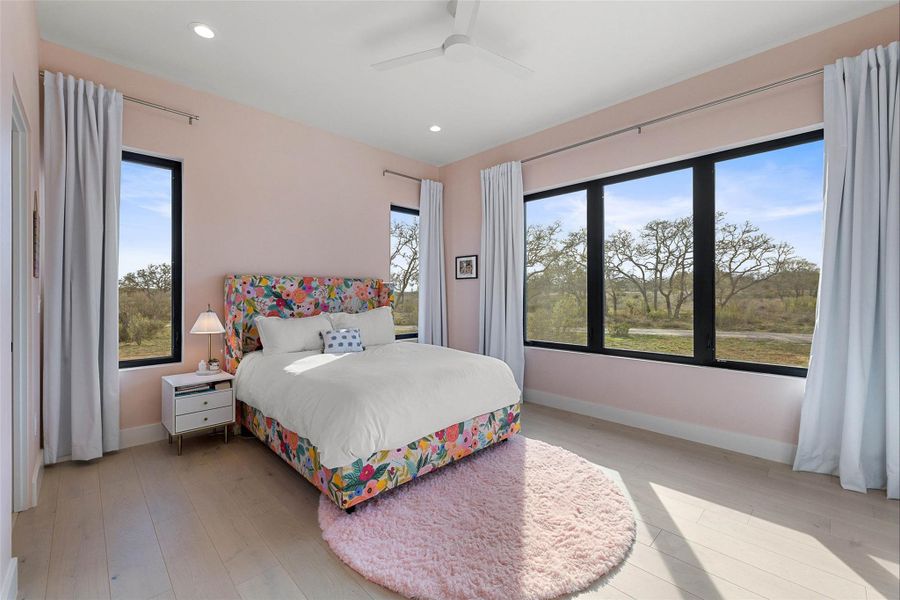 Bedroom with multiple windows, recessed lighting, light wood-style floors, and ceiling fan
