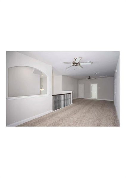 Carpeted spare room with ceiling fan