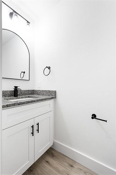 Bathroom with light wood-style flooring and vanity