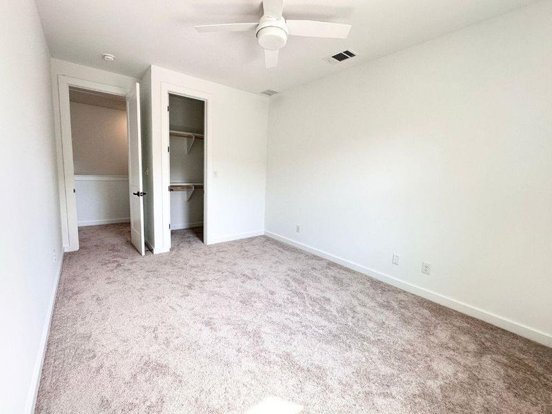 An inviting bedroom features plush carpeting and a convenient closet, perfect for comfortable living. An inviting bedroom features plush carpeting and a convenient closet, perfect for comfortable living.