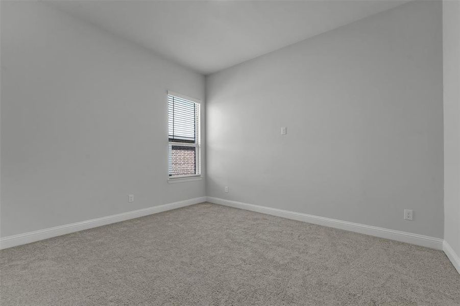Spare room with light colored carpet and baseboards