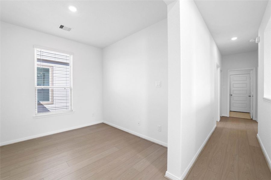 From the Den into the hallway leading you to the secondary bedrooms, bathroom, and laundry room.