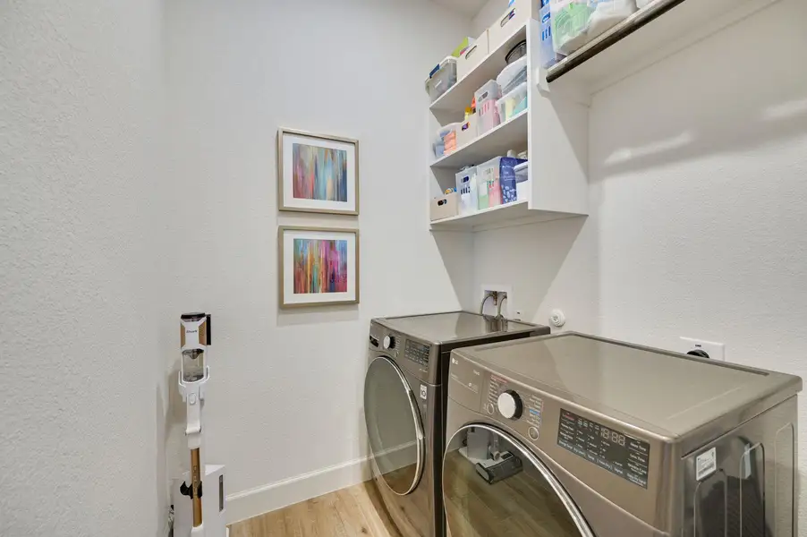 Large laundry room big enough for an additional refrigerator.