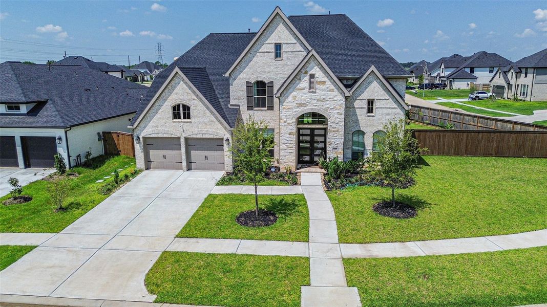 Dual-width driveway with an extended walkway leading to the covered porch and street. Dual-width driveway with an extended walkway leading to the covered porch and street.