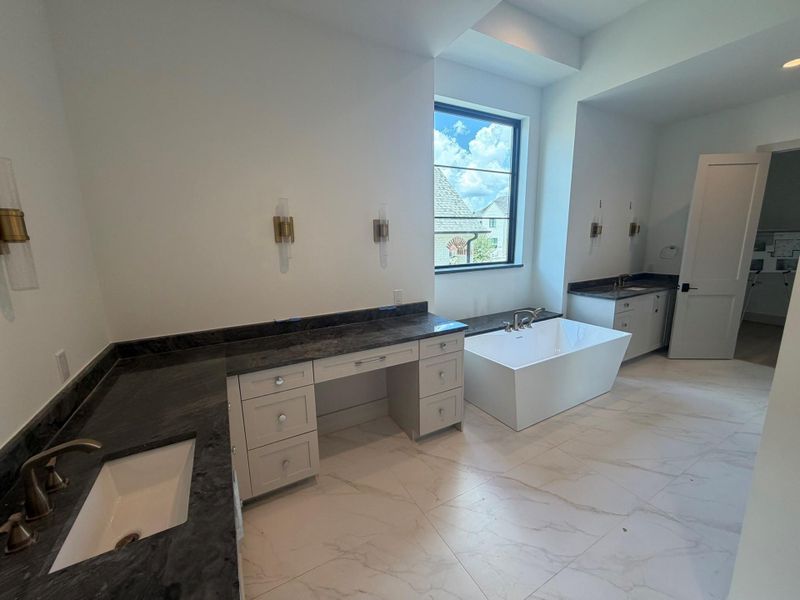 This alternate angle shows the vessel tub with stone ledge, double sinks and seated vanity. This progress photo was taken August 11.