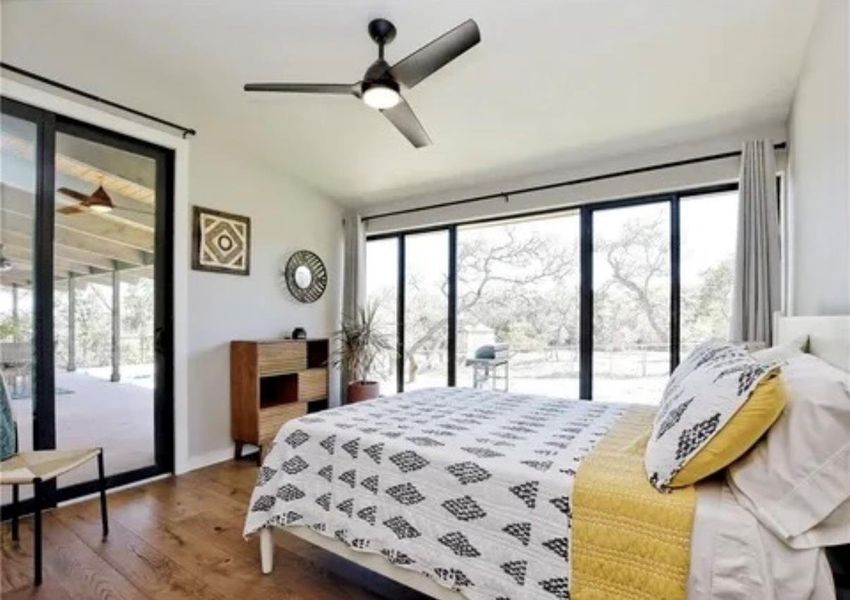 Bedroom with access to exterior, dark wood-type flooring, and ceiling fan Bedroom with access to exterior, dark wood-type flooring, and ceiling fan