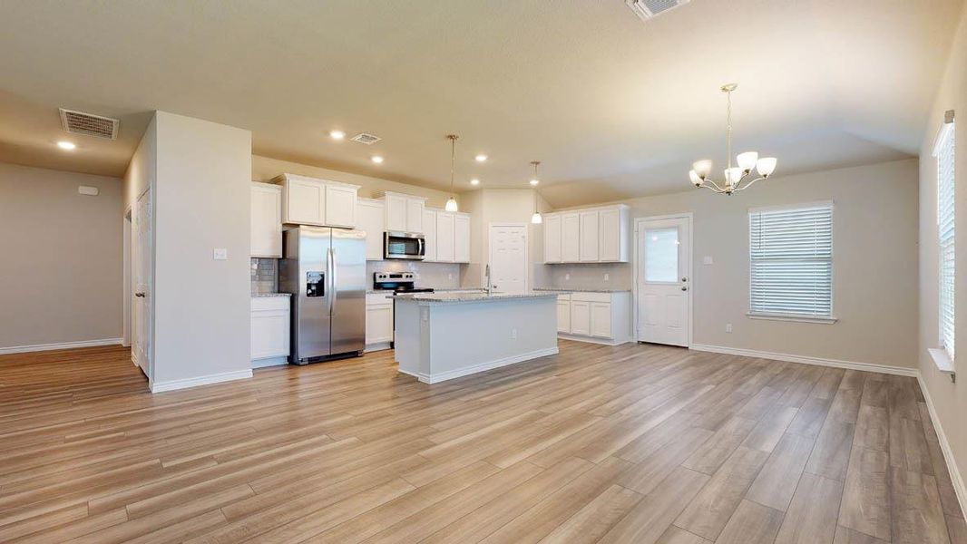 Open-concept living space with wood-finish flooring
