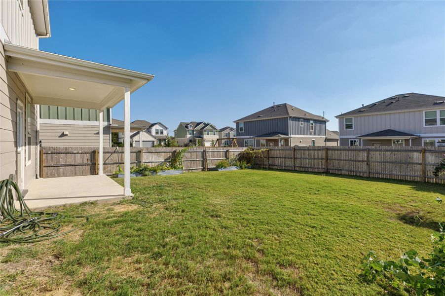 Fenced backyard featuring a patio and a residential view