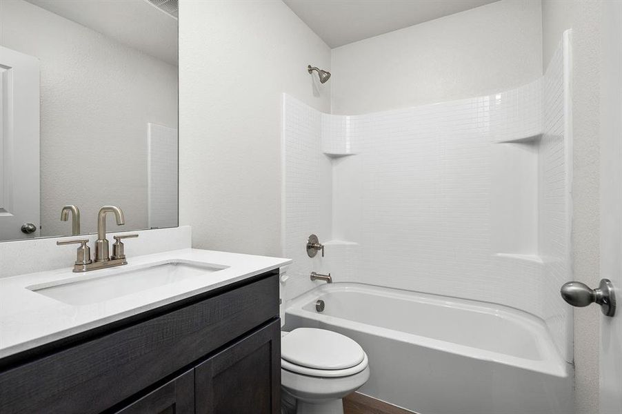 Bathroom with shower / tub combination, toilet, and vanity Bathroom with shower / tub combination, toilet, and vanity