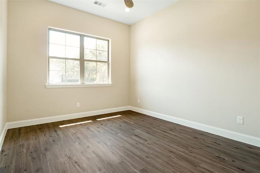 Empty room with dark hardwood / wood-style flooring