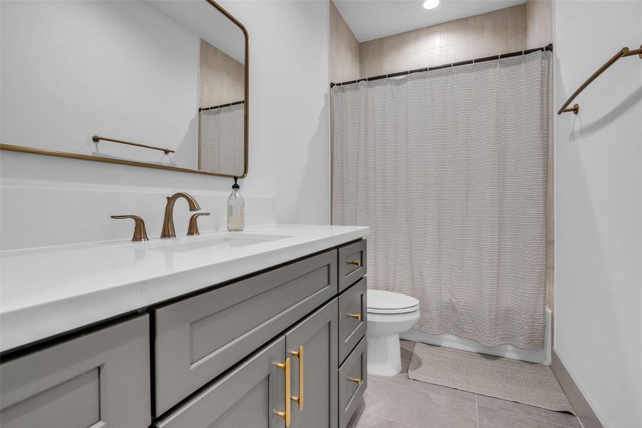 Third-floor bathroom features a tub and shower combination, conveniently serving the rooms on this level with a functional and accessible layout.