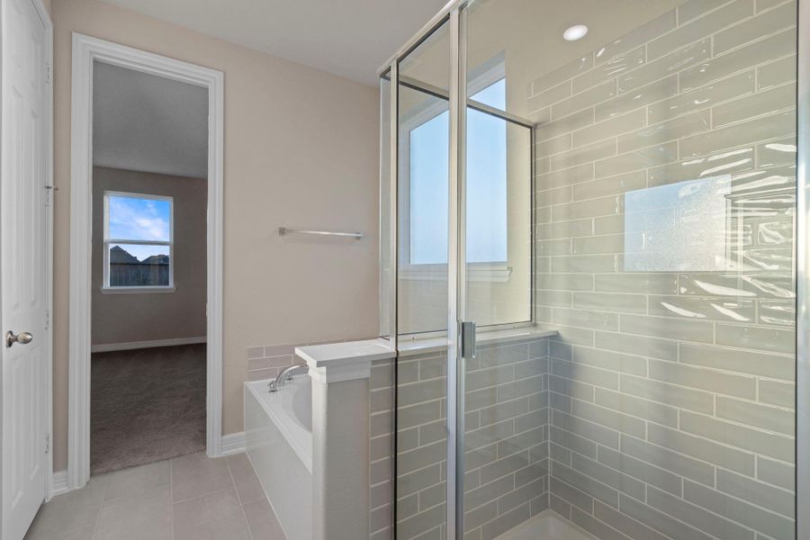 This additional view of your primary bathroom features tile flooring, fresh paint, walk-in shower, a separate garden tub, and a large walk-in closet. This additional view of your primary bathroom features tile flooring, fresh paint, walk-in shower, a separate garden tub, and a large walk-in closet.