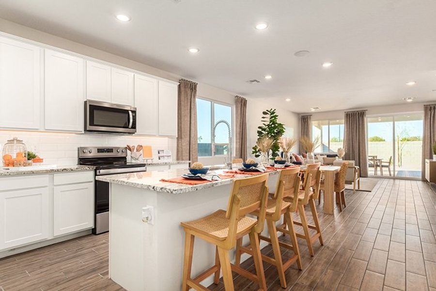 A kitchen with a dining table and chairs. A kitchen with a dining table and chairs.