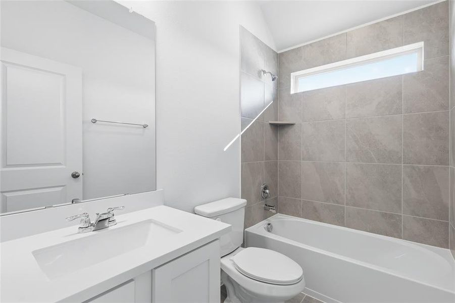 Bathroom featuring a white vanity with integrated sink, chrome faucet, and full-width mirror