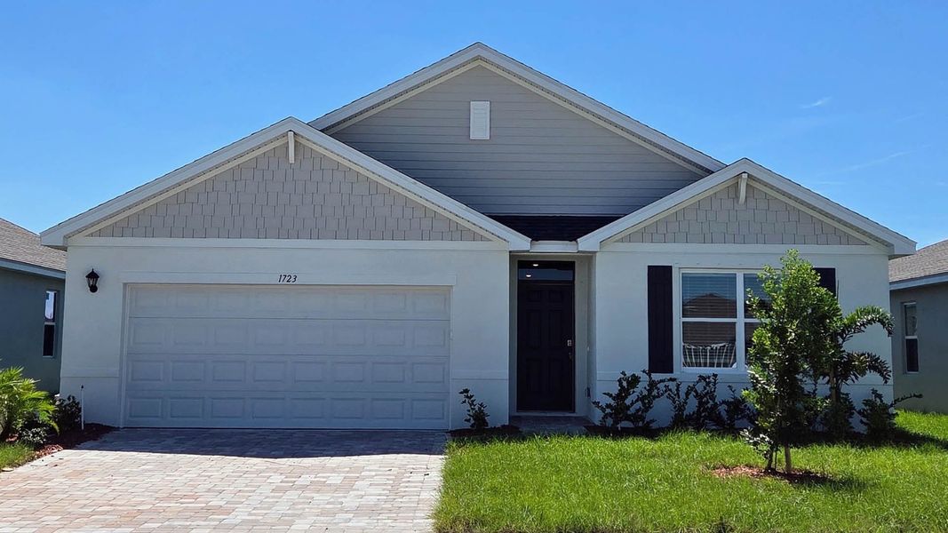 Front exterior of a new home in Cypress Bay West, Palm Bay, FL, highlighting curb appeal (Image 1). Front exterior of a new home in Cypress Bay West, Palm Bay, FL, highlighting curb appeal (Image 1).