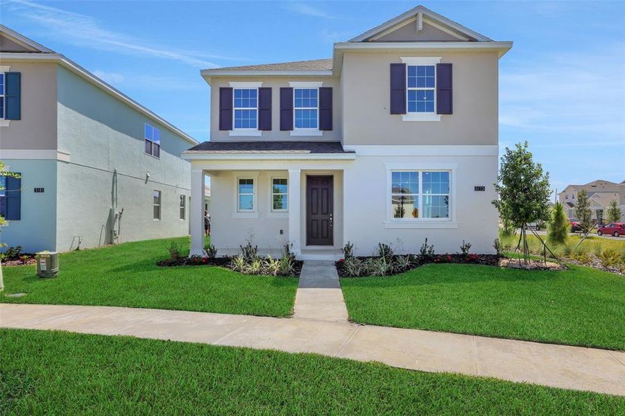 Front exterior of a new home in Crossroads at Kelly Park, Apopka, FL, highlighting curb appeal (Image 1). Front exterior of a new home in Crossroads at Kelly Park, Apopka, FL, highlighting curb appeal (Image 1).