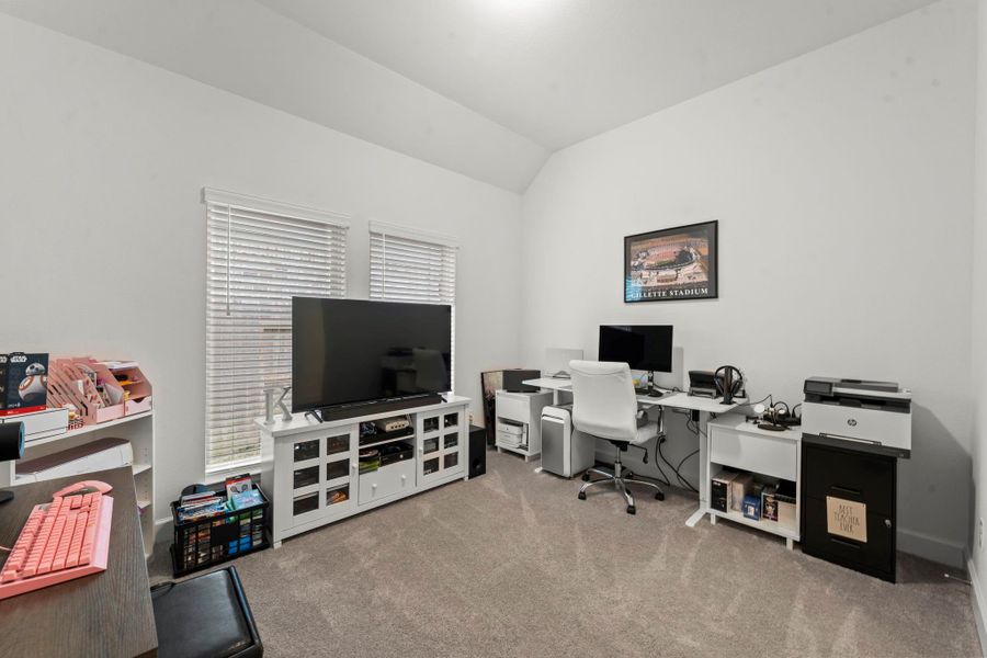 This bonus room can be used for an office, game, or media room. It features lush carpeting, sloped ceiling, two large windows with 2" blinds for natural lighting, and a ceiling light.