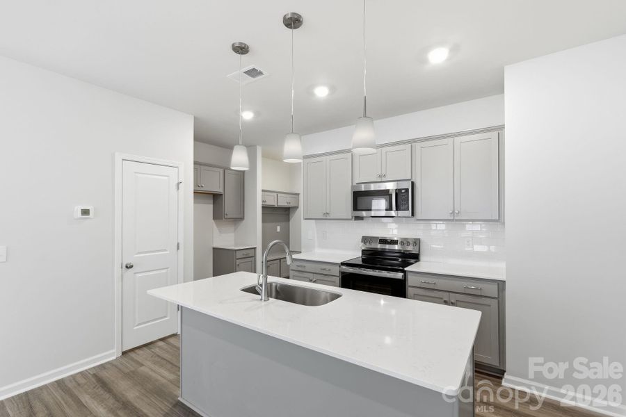 Kitchen with Quartz Countertops and soft-close cabinet doors