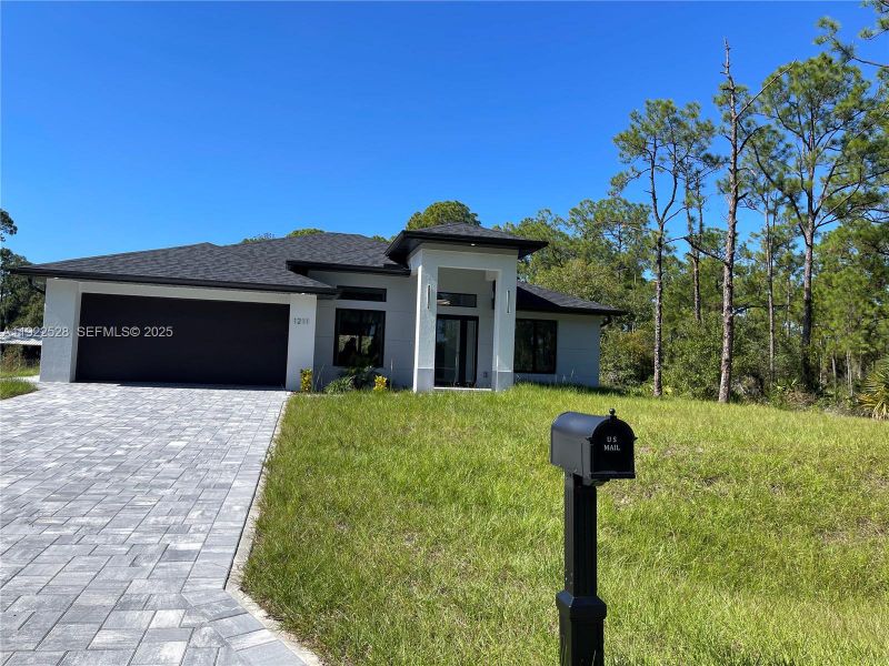 Front exterior of a new home in , Lehigh Acres, FL, highlighting curb appeal (Image 21). Front exterior of a new home in , Lehigh Acres, FL, highlighting curb appeal (Image 21).