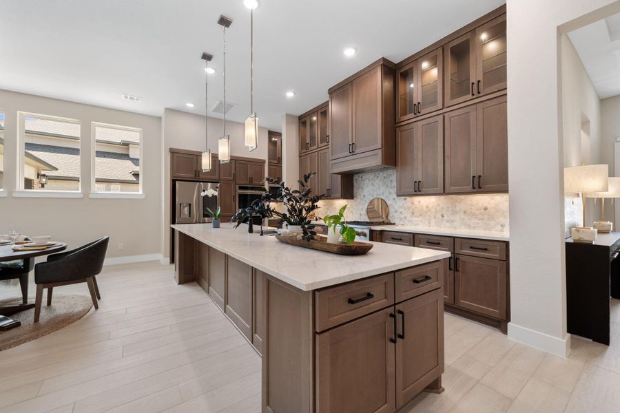 The stunning kitchen, combining style, function, and high-end finishes. A spacious island with sink serves as the centerpiece, offering plenty of room for meal prep, entertaining, and casual dining. The stunning kitchen, combining style, function, and high-end finishes. A spacious island with sink serves as the centerpiece, offering plenty of room for meal prep, entertaining, and casual dining.