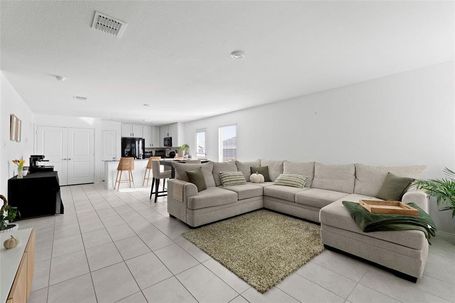 Living area featuring light tile patterned flooring