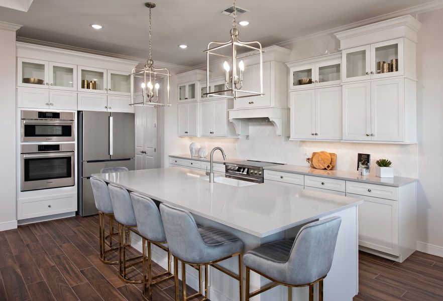 Kitchen with pendant lighting and glass upper cabinets