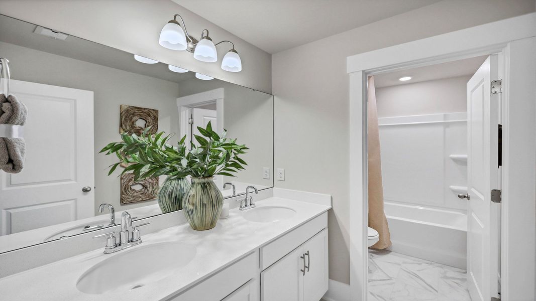 Representative furnished interior of a home built from the Harbor Oak by D.R. Horton in Lake Tide Summit, Chapin (Image 50).
