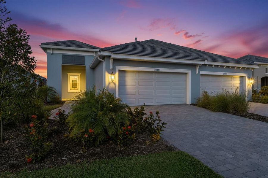 Front exterior of a new home in Palm Grove, Lakewood Ranch, FL, highlighting curb appeal (Image 1). Front exterior of a new home in Palm Grove, Lakewood Ranch, FL, highlighting curb appeal (Image 1).