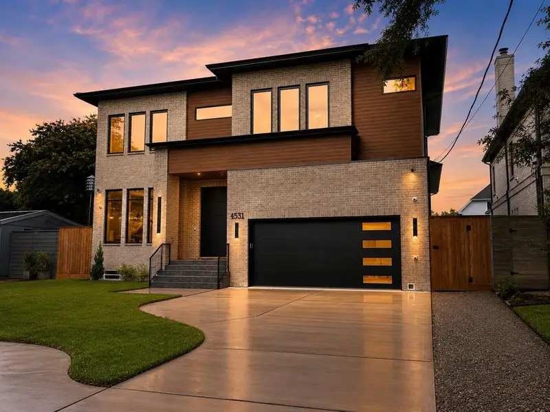 [FRONT ELEVATION] Sophisticated contemporary architecture meets timeless brick construction in this beautifully crafted residence, offering sleek lines and undeniable curb appeal.