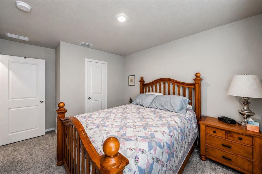 Neutral-toned wall paint with recessed ceiling lighting, a textured carpeted floor, and white paneled doors
