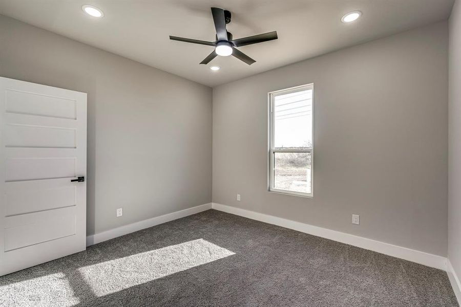 Unfurnished room with recessed lighting, a ceiling fan, dark colored carpet, and baseboards