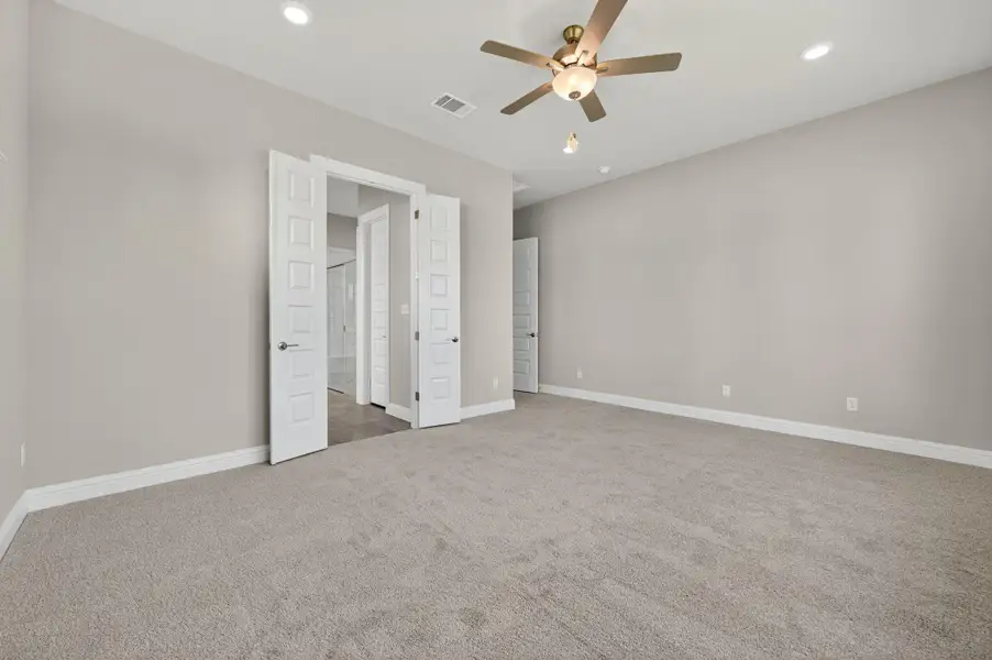 Unfurnished bedroom with light colored carpet, recessed lighting, and ceiling fan