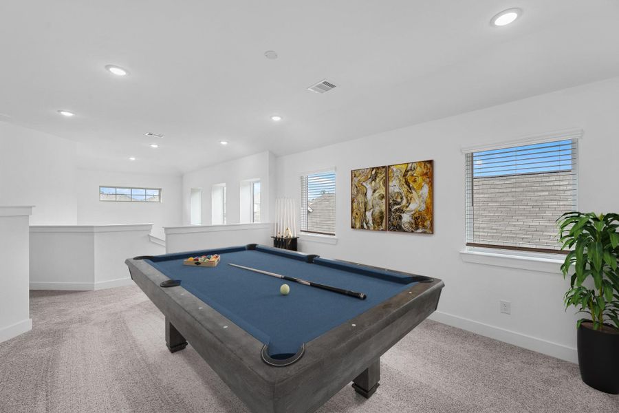 As you make your way upstairs this exceptional game room is a standout feature in this remarkable property, offering a space that combines luxury and fun for all ages. Virtually staged to show furniture placement.