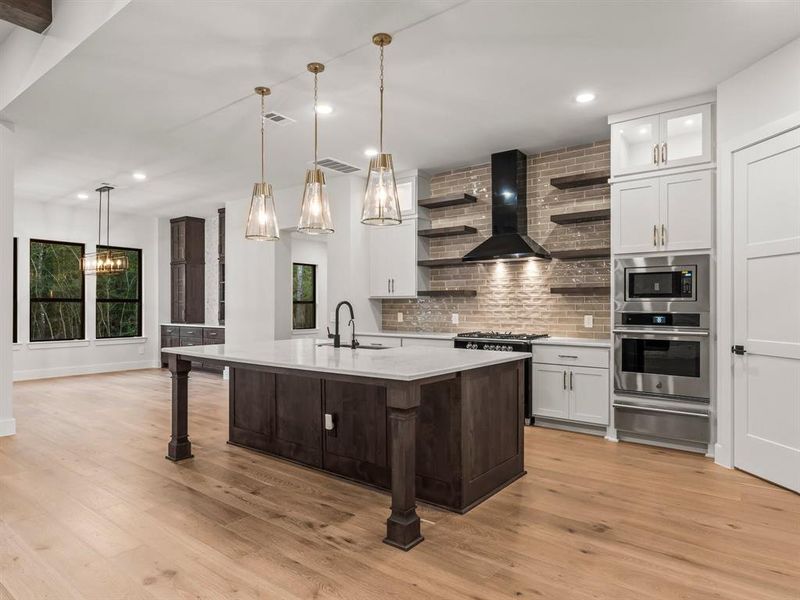 Gorgeous Kitchen with Seating at the Island Pendant Lighting, and Custom Floating Shelving.