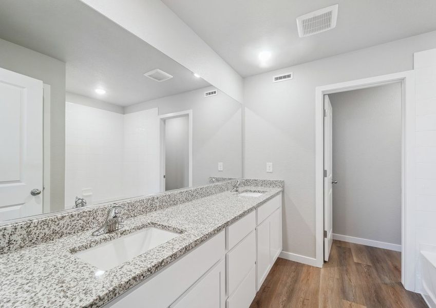 The master bathroom has a dual sink vanity and a tub/shower combo.