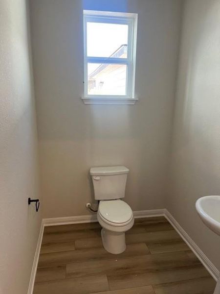 Bathroom featuring toilet and light wood-style floors